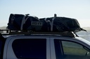 Gear bag strapped to vehicle roof rack